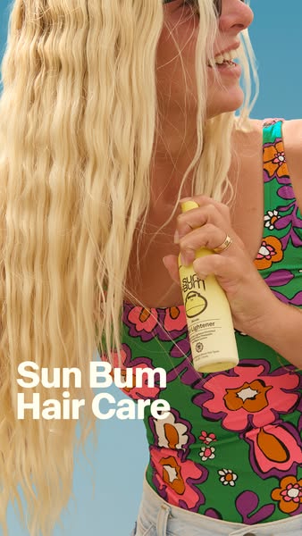 This ad for Sun Bum hair care features a woman with long blonde hair applying the product. The image highlights the prod