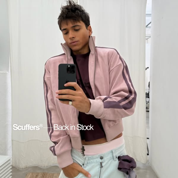 This is a photo ad announcing the restock of a Scuffers jacket. A person, presumably a customer or influencer, is seen w