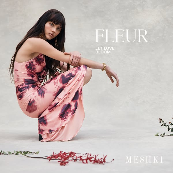 This is an image ad for Meshki promoting their Fleur dress. The model is seen crouching in front of a neutral background