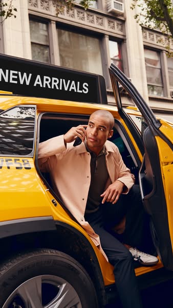 This ad features a man stepping out of a yellow taxi while on a cell phone. Above the taxi reads "New Arrivals.&quo