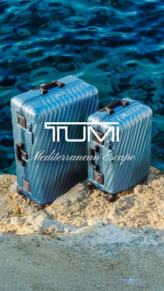 A luxury luggage ad shows two TUMI suitcases sitting on a rocky ledge with crystal blue water behind them. The brand log