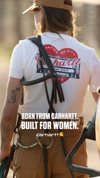 This image ad is for Carhartt women's apparel. It shows a woman from the back wearing a Carhartt t-shirt and brown p