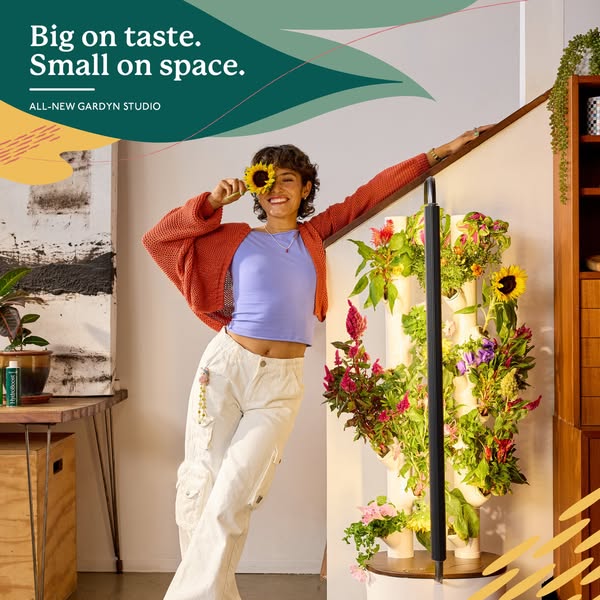 This ad is for Gardyn Studio, a vertical indoor garden. The ad features a woman standing next to a Gardyn Studio, a vert