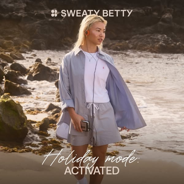 This ad features a woman wearing Sweaty Betty apparel at the beach and is meant to evoke a carefree vacation vibe.