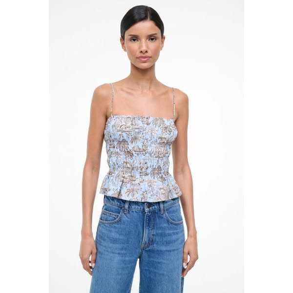 This ad features a woman wearing a light blue top with a tropical print and jeans. The ad is a simple product display.