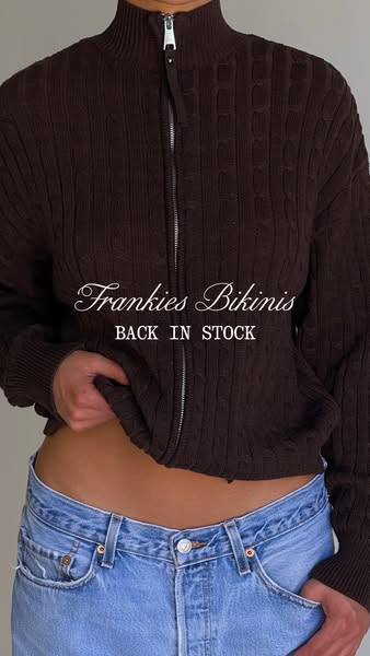 This ad features a woman wearing a brown cable knit cardigan. The ad highlights that this cardigan is back in stock.