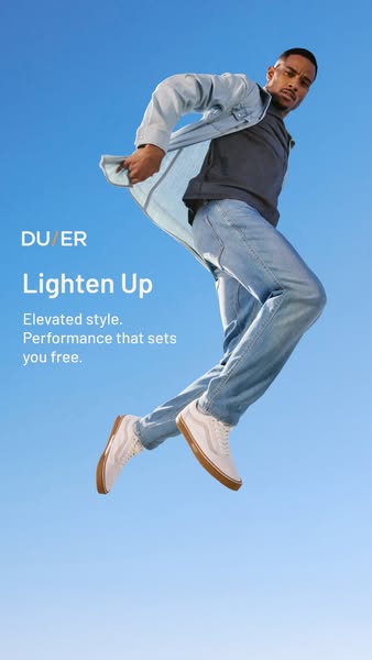 This image ad showcases DU/ER clothing, focusing on their light-colored jeans and jacket. It features a man jumping agai