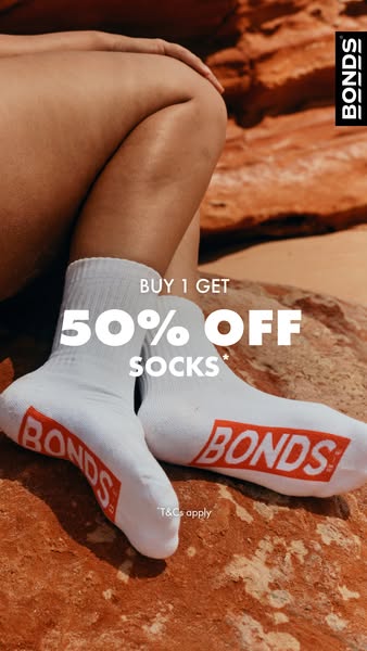 This image ad promotes Bonds socks with a BOGO 50% off deal. It features a close-up shot of a person wearing a pair of w
