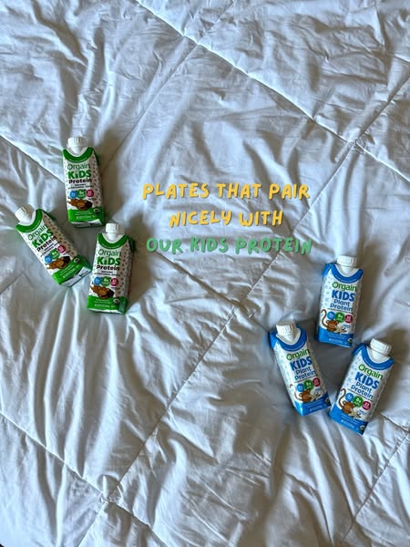 This image ad features six Orgain Kids Protein drinks arranged on a white comforter. The central message suggests that t