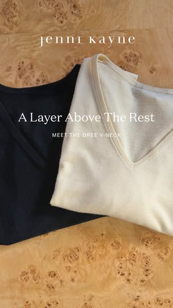 This ad features a Jenni Kayne brand V-neck shirt in two different color variations in front of a wooden surface. The ad