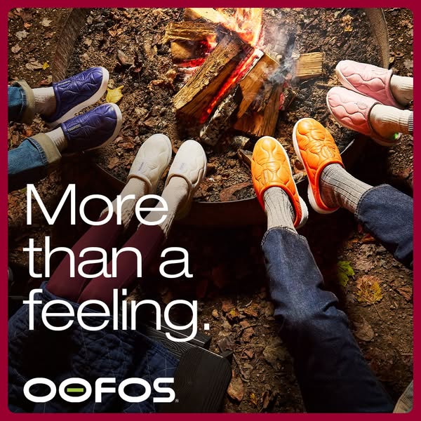 This ad features a lifestyle image of people wearing OOFOS shoes around a campfire. The ad emphasizes the comfort and fe