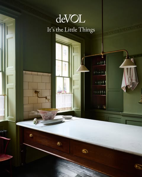 This ad features a kitchen scene with an island, sink, and open cabinet filled with various bottles. The ad’s purpose is