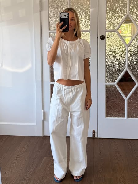 This ad features a woman wearing a matching white pajama-style set consisting of a puff-sleeved short top and loose pant