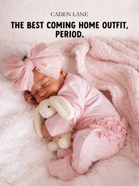 An image ad for Caden Lane shows a baby dressed in a pink coming home outfit sleeping on a white furry blanket with a sm