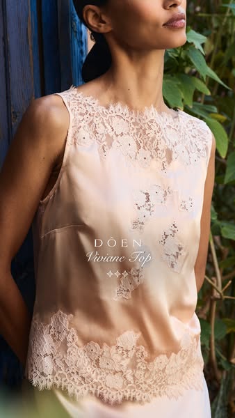 This image ad showcases a woman wearing a pale pink top from the brand DOEN, highlighting the top's design and brand