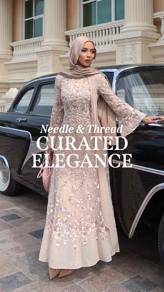 An ad for Needle & Thread featuring a woman in a formal dress, posed in front of a vintage car.