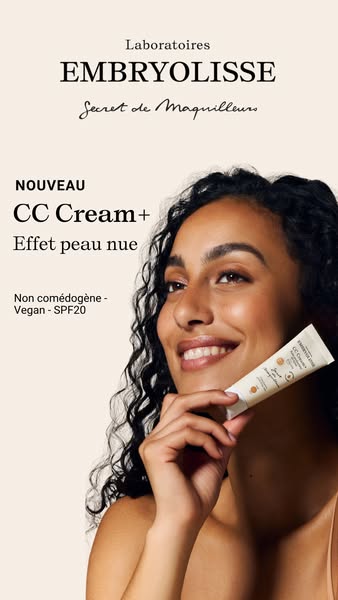 Image ad for Embryolisse CC Cream featuring a woman holding the product and smiling.