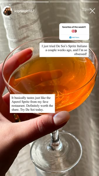 A user-generated Instagram story ad for De Soi's Spritz Italiano. The ad features a hand holding a coupe glass fille
