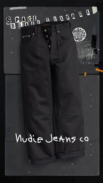 This ad features Nudie Jeans, showcasing a pair of their black 'Space Black Selvage' denim jeans. The ad has a r