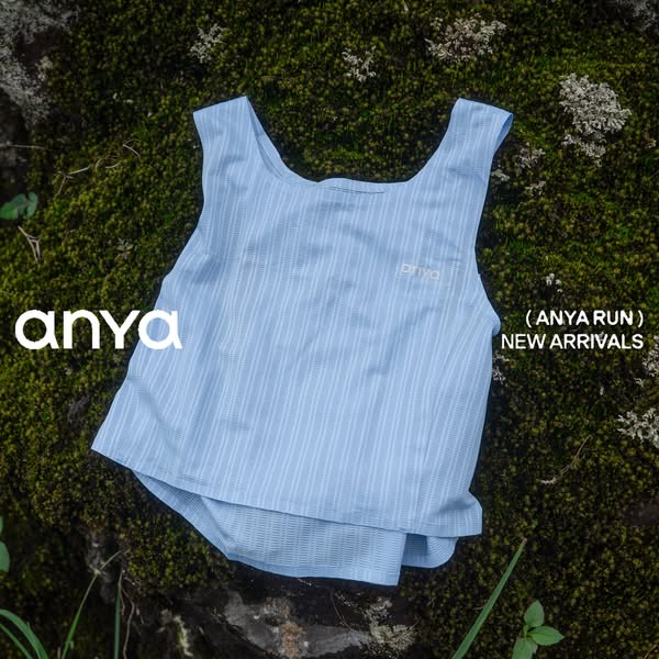 This ad for Anya Run features an image of a light blue athletic top laid out on a mossy surface, presumably outdoors. Te