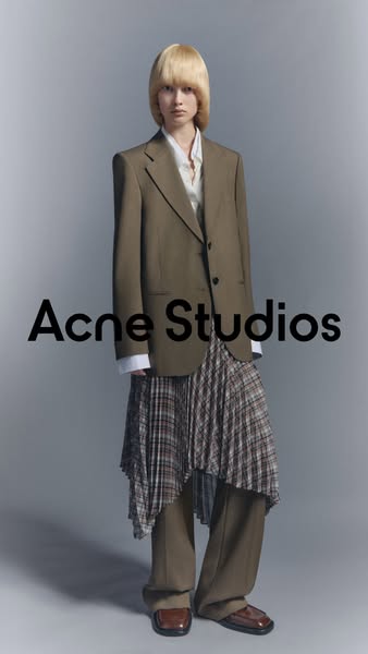 This ad features a full-body shot of a model wearing Acne Studios clothing. The brand name is prominently displayed in t