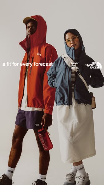 A landscape shot of a man and a woman wearing The North Face outwear. The ad's headline emphasizes the brand's s