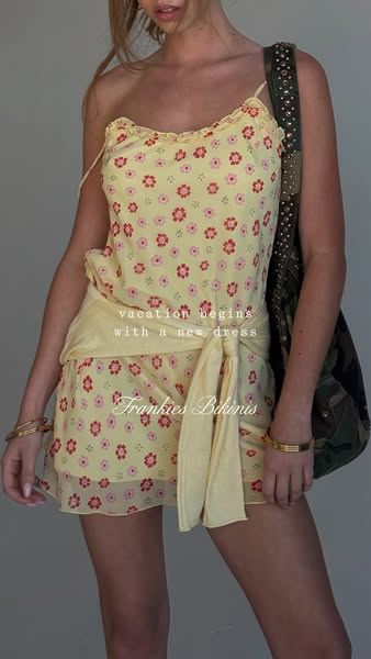 This ad features a woman wearing a floral dress from Frankies Bikinis, suggesting that their clothing is ideal for vacat