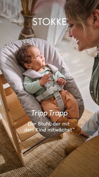 An eye-level shot captures a mother gazing lovingly at her baby, who is seated in a Stokke Tripp Trapp high chair. The s