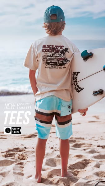 This ad for Salty Crew youth tees shows a child from the back wearing a Salty Crew shirt and board shorts on the beach h