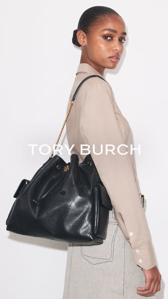 This ad features a high-fashion image of a woman wearing a Tory Burch bucket bag. The ad primarily showcases the luxury 