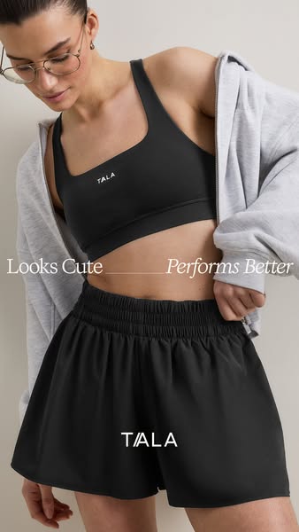 This ad features a woman in athletic wear, specifically a black sports bra and black shorts from the brand TALA. The ad 