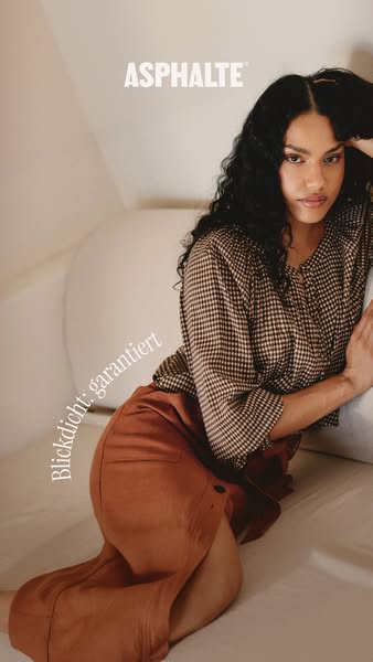 An eye-level image features a model leaning against a neutral-colored surface, showcasing Asphalt clothing. The brand lo