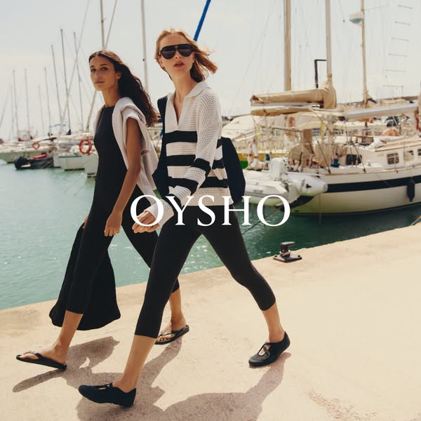An image ad for Oysho featuring two women wearing Oysho clothing while walking along a marina.