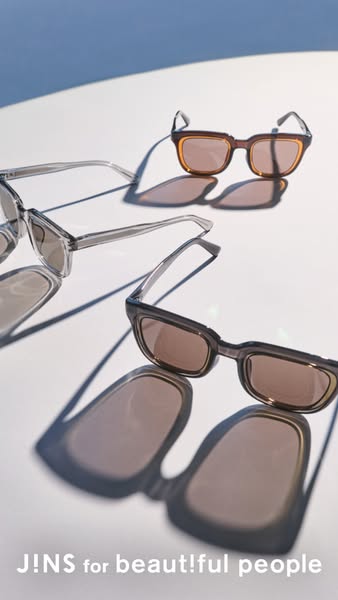 This ad showcases JINS eyewear. The ad features three pairs of sunglasses on a white surface, highlighting their design 