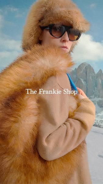 This ad features a woman in winter clothing in front of a snowy mountain range with the brand's logo in the lower le