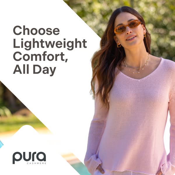 An image ad for Pura Cashmere that showcases a model wearing a pink v-neck sweater while standing outside. A white block