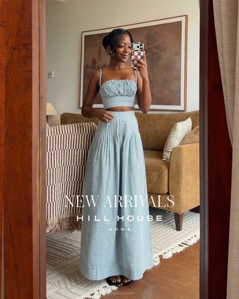 This ad features a woman posing in a mirror wearing a light blue two-piece gingham outfit, promoting new arrivals from H
