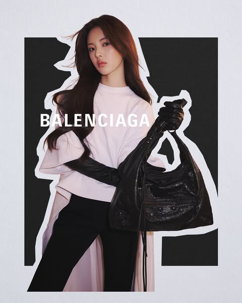 This ad features a high-fashion image of a model holding a Balenciaga handbag with the brand name overlayed. The creativ