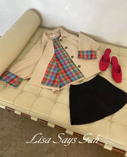An image ad featuring a Lisa Says Gah button-down top, skirt, and heels arranged on a bench.