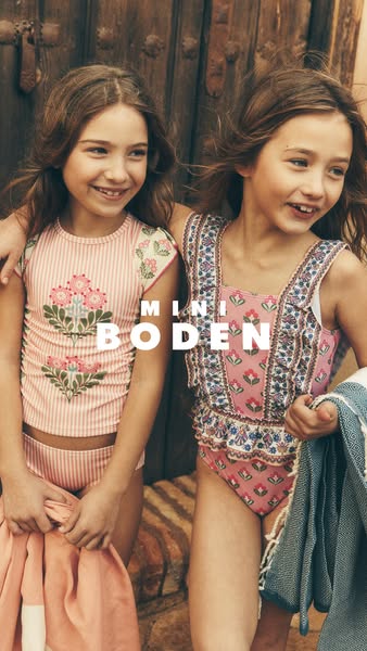 This image features two young girls wearing Mini Boden swimwear. The ad promotes the brand Mini Boden and showcases thei