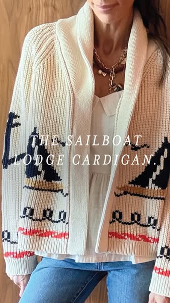 This image ad showcases a lodge cardigan featuring a sailboat design, targeting an audience interested in unique and coz