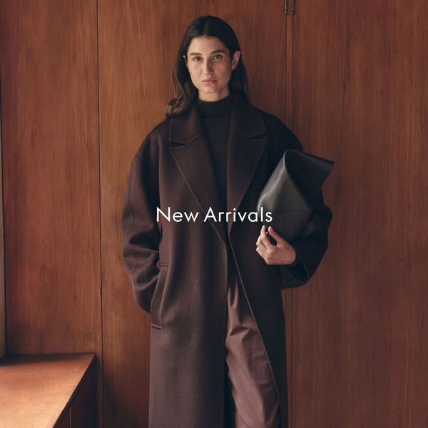 This image ad features a woman in a long brown coat, holding a large black handbag. The text overlay states, "New A