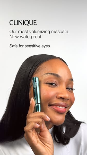 This Meta image ad for Clinique features a woman holding the brand's volumizing mascara, with the text overlay speci