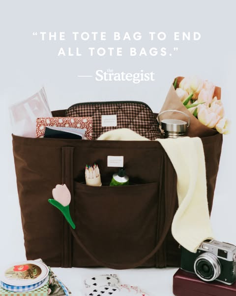 This ad features a brown tote bag, open to reveal various items inside. A quote from The Strategist is highlighted, posi
