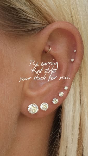 This ad features a close-up view of a woman's ear adorned with multiple diamond stud earrings of varying sizes along