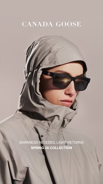 This ad for Canada Goose features a person wearing a grey hooded jacket and sunglasses. The ad highlights the brand'