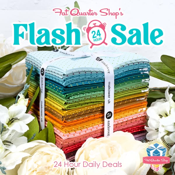This image ad showcases a stack of colorful fabric fat quarters from Fat Quarter Shop. The ad promotes a flash sale and 