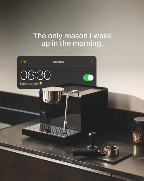 This image ad features a sleek, black espresso machine on a dark countertop, positioned as the primary reason someone wo