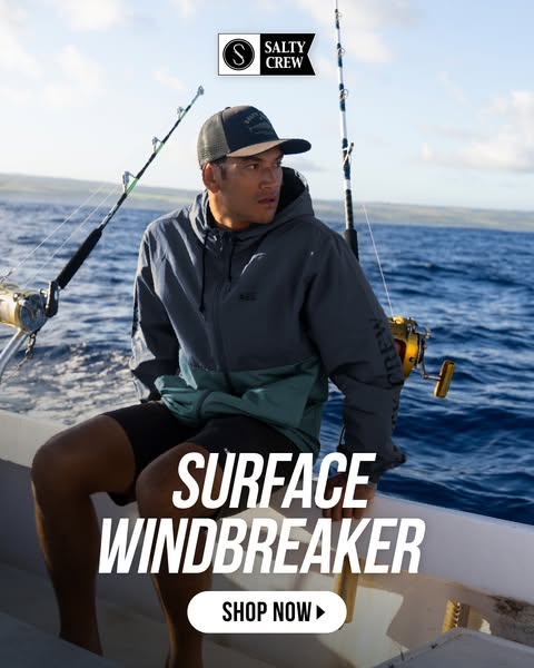 A lifestyle product image ad for Salty Crew's Surface Windbreaker features a man on a boat, fishing. The ad contains
