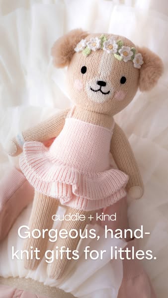An image ad featuring a knitted doll to advertise cuddle + kind, which creates hand-knit gifts for children.